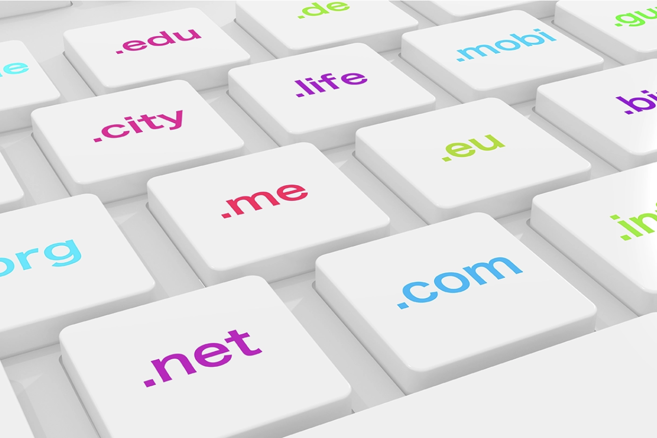 How to choose a domain name blog image. A keyboard with domain tlds on the keys.